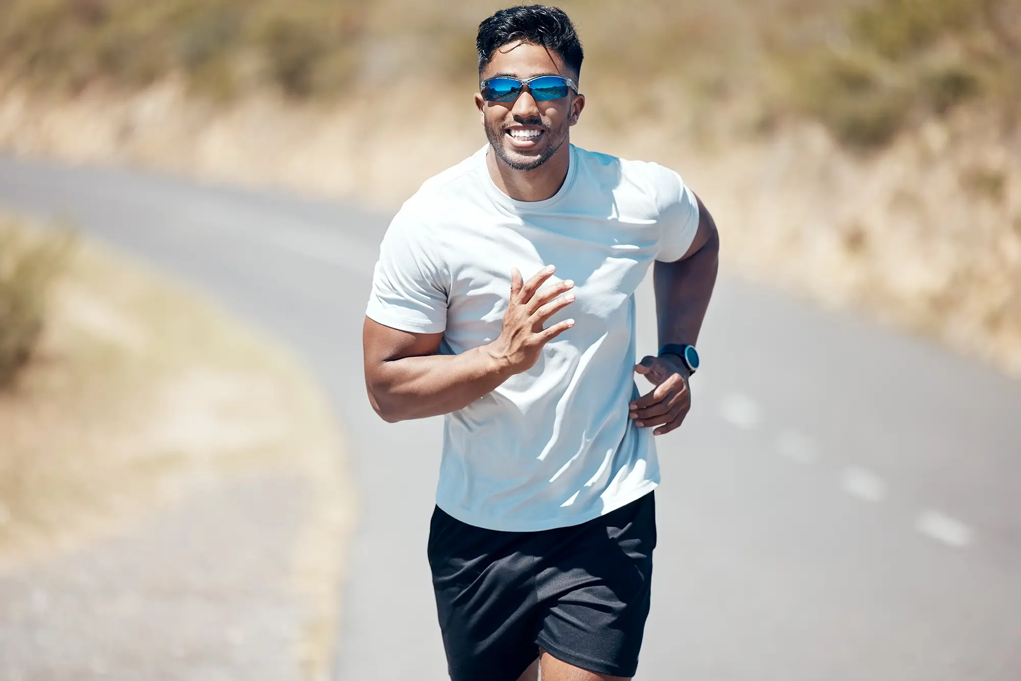 Hispanic male exercising outside during a run in the road outdoors